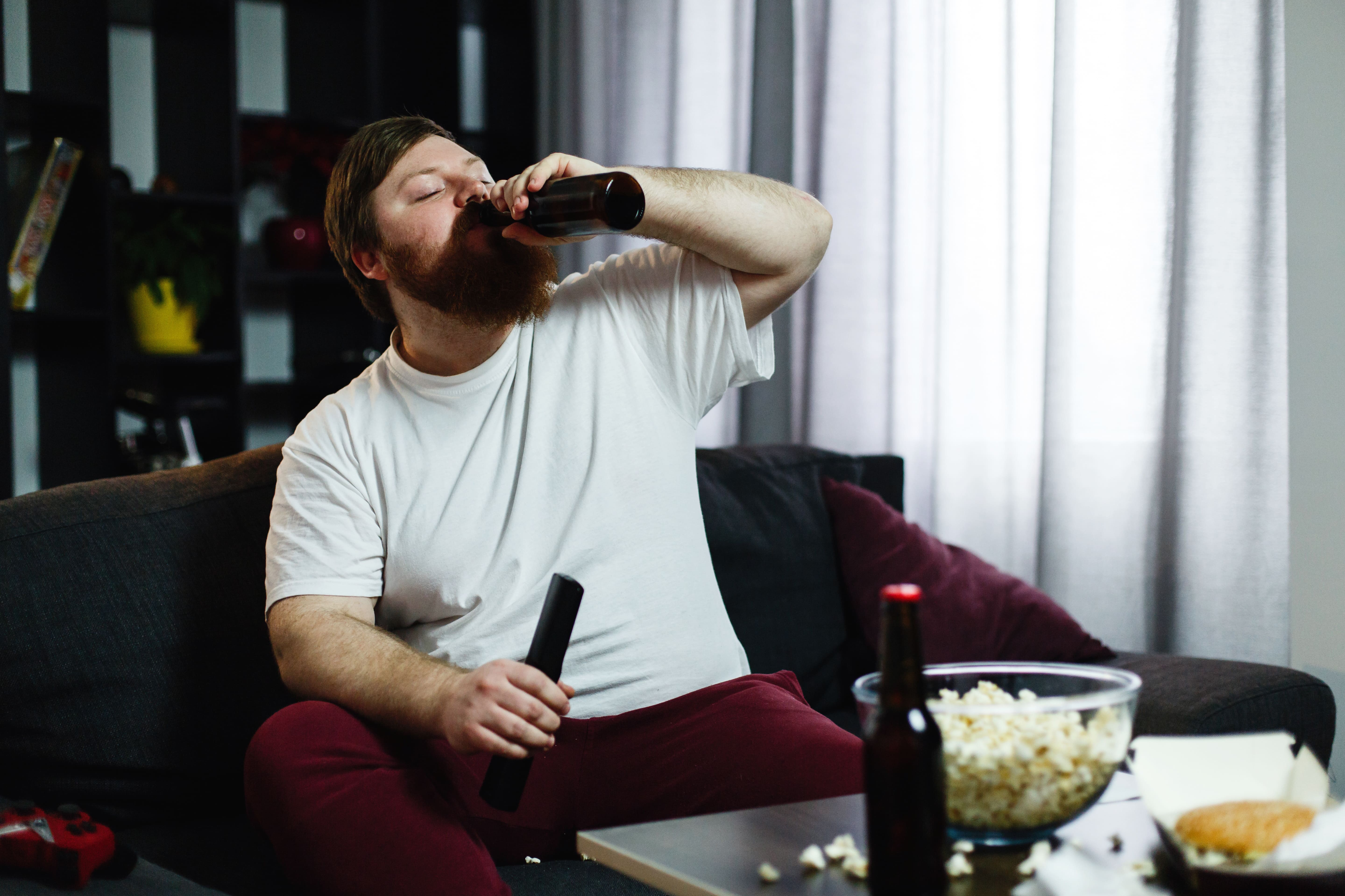 fat-man-drinks-beer-lying-sofa (1).jpg